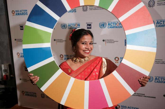 Suvarna Raj holds a banner of a UN SDG Awards