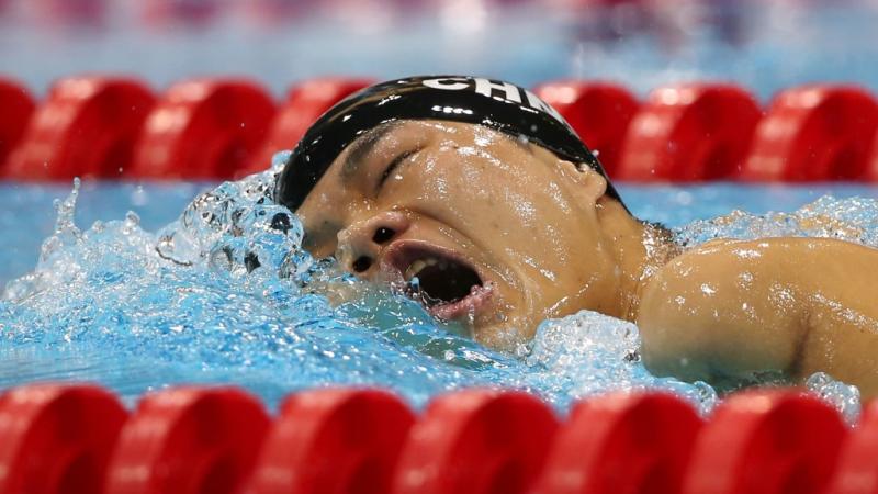 Tao Zheng from China competes at London 2012 Swimmer in the water breathing between two freestyle strokes