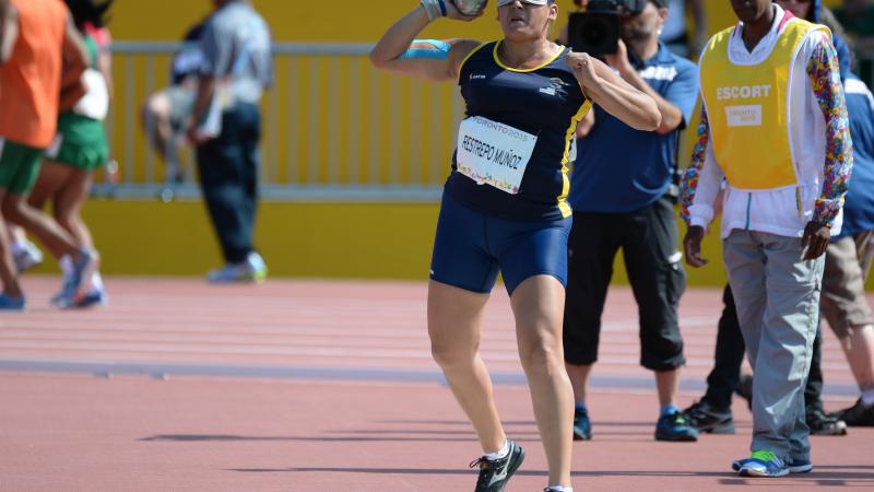 Blindfolded man throwing a shot put