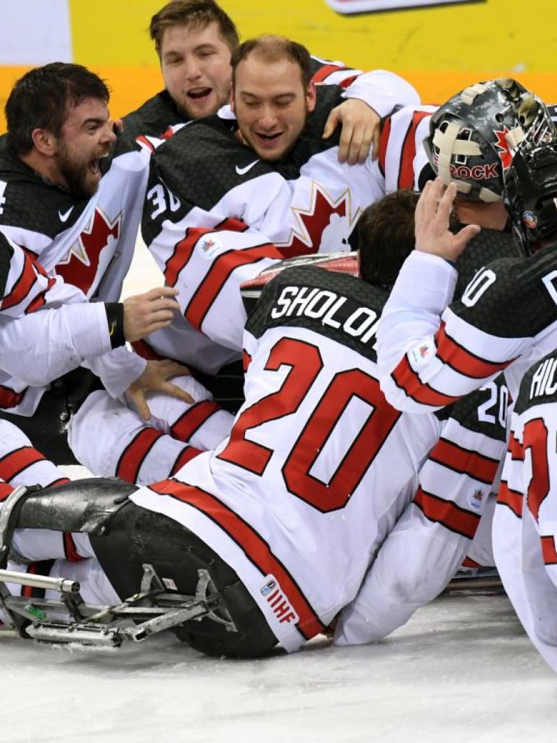 A group of Para ice hockey players celebrating.
