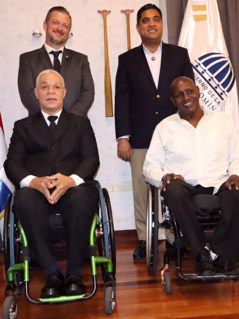 IPC President Andrew Parsons poses for a photo with three male officials