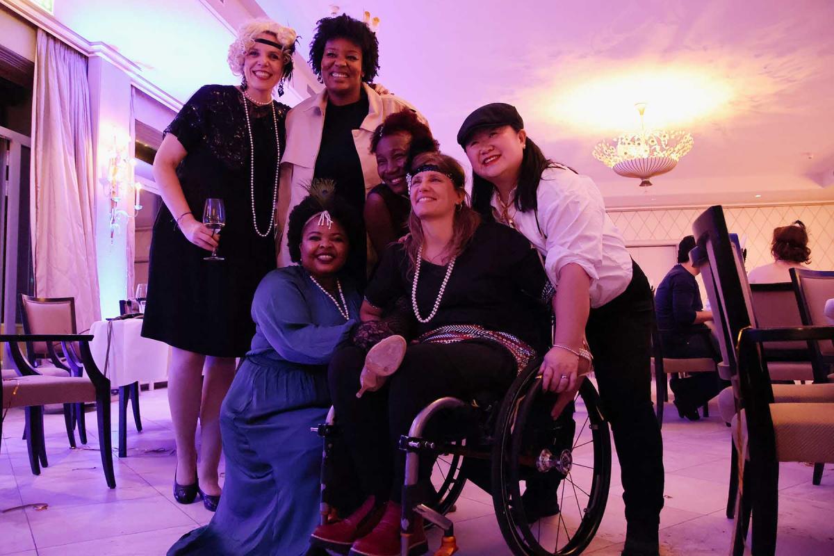 Six IPC staff members smile and pose for a photo during the IPC winter party in 2024