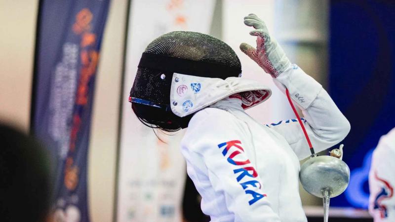 a south korean female wheelchair fencer in action 