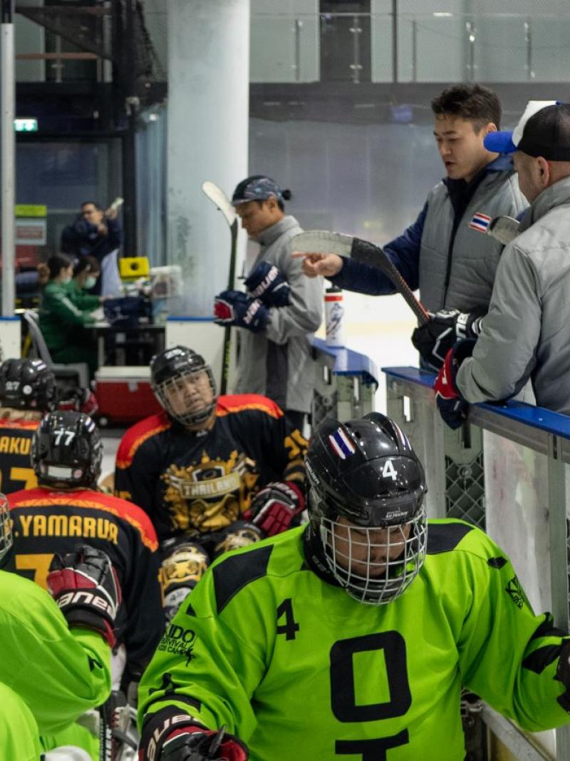 Players enter the ice hockey rink