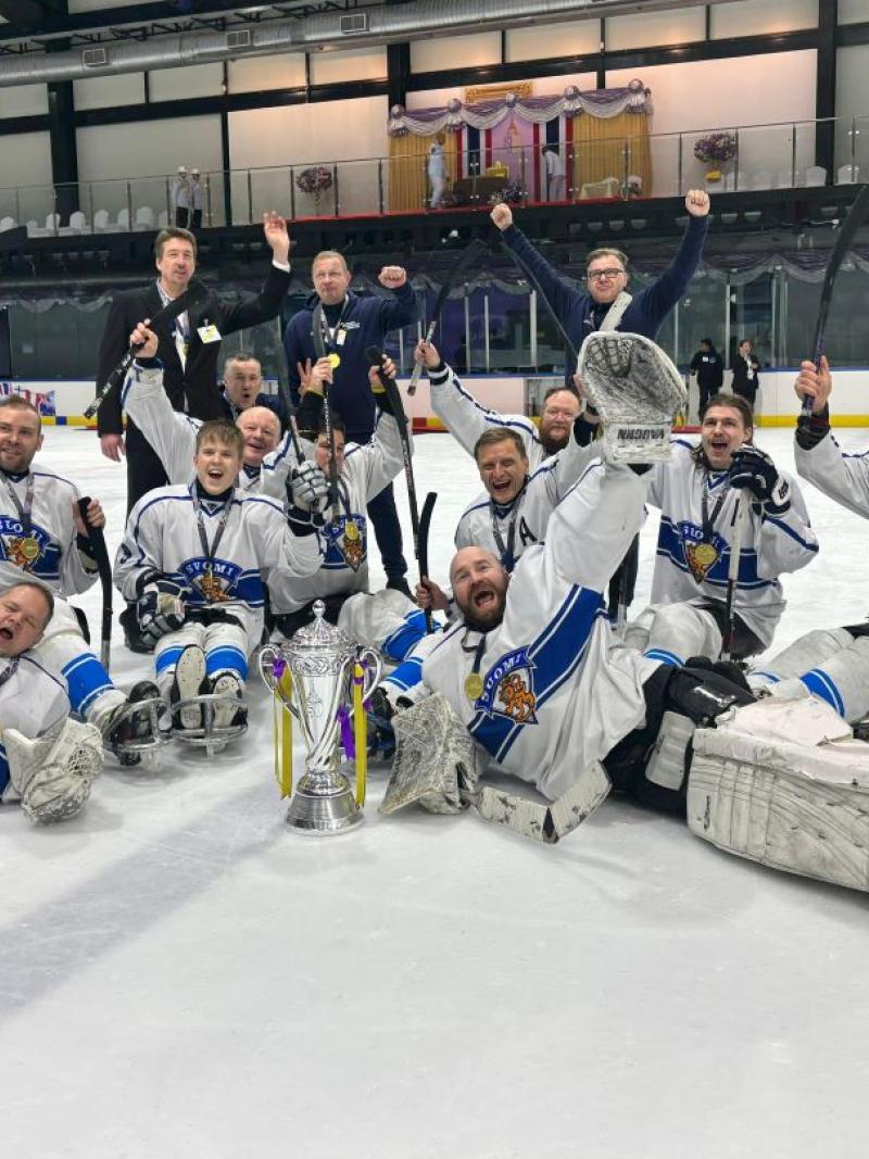 Finland Para ice hockey national team celebrating on an ice rink