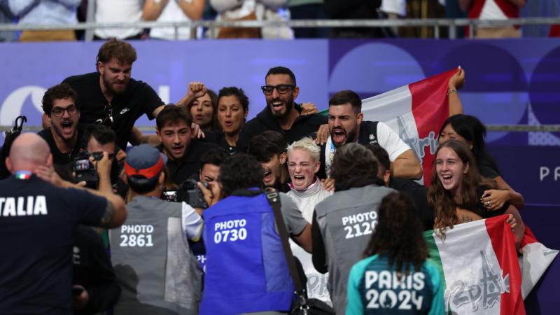 Bebe Vio cheering surrounded by fans and photographers