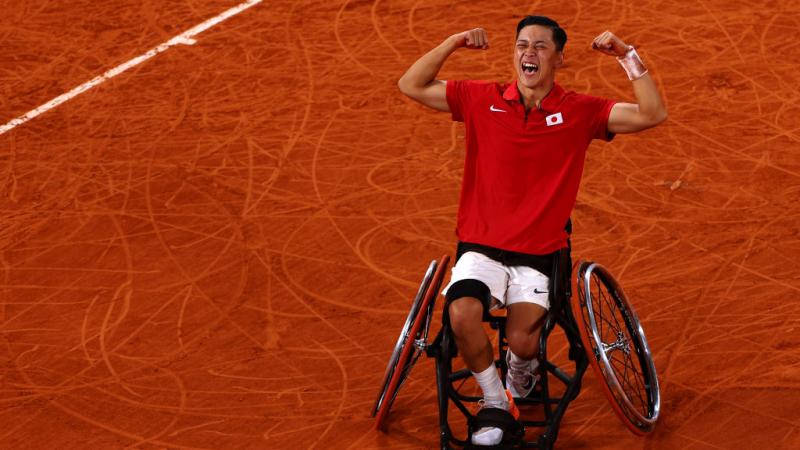 Wheelchair tennis player Tokito Oda screams with joy on a clay court