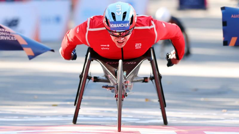 A male wheelchair racer crossing the finish line in the 2024 New York City Marathon