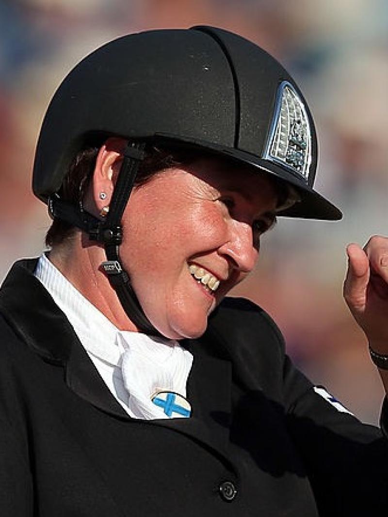 Para equestrian rider Katja Karjalainen smiling and waving on her horse