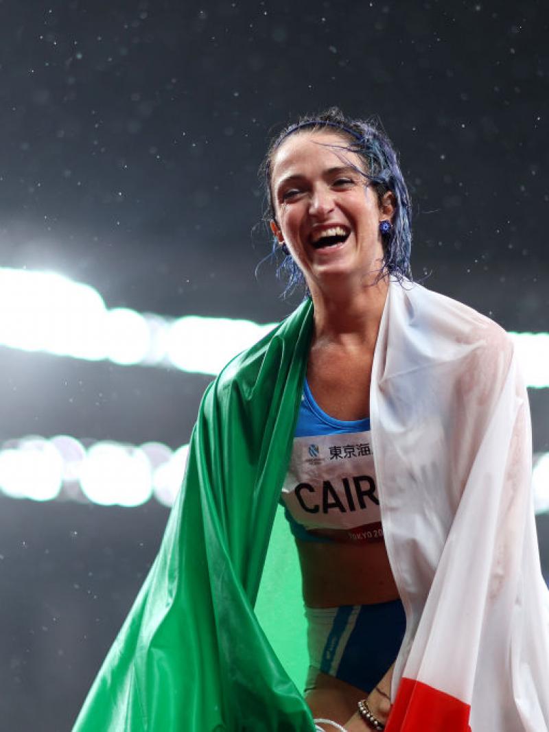 Para sprinter Martina Caironi laughing with the Italian flag wrapped round her