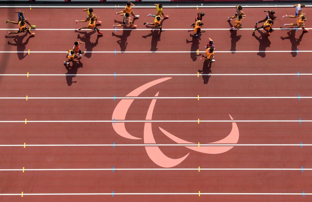 Overhead photo of athletes and their guides running on the track.